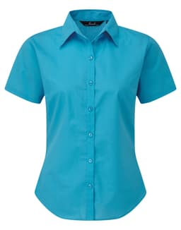 A short-sleeved button-up shirt in bright turquoise, featuring a collar and front buttons. Includes a logo.