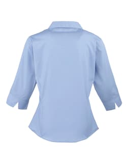 A light blue women's 3/4 sleeve poplin blouse with a button-up design and a collar, featuring a fitted shape.