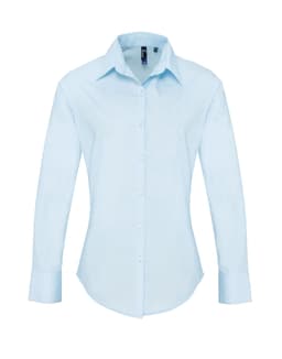 Light blue women's long-sleeve button-up shirt with a collar, featuring a logo on the chest.