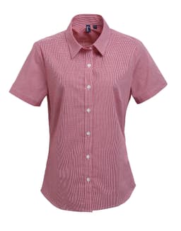 A short-sleeved women's shirt in red microcheck pattern, featuring a button-up front and a collar. Includes a logo.
