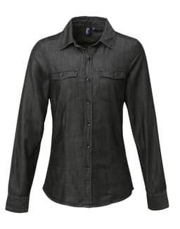A women's button-up shirt in dark denim with long sleeves and two chest pockets. Features branding on the label.