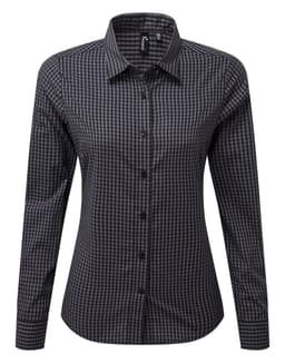 A black and white checked button-up shirt with long sleeves and a collar. Features a branding logo.