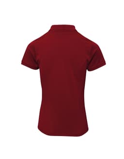 A red women's polo shirt with a classic collar, featuring a fitted design and short sleeves. It has a logo on it.