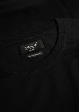 A black knitted jumper featuring a round neckline and a branded label inside.