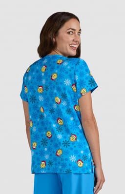 A blue top featuring a playful pattern of smiling faces and snowflakes. The back view displays a vibrant design.