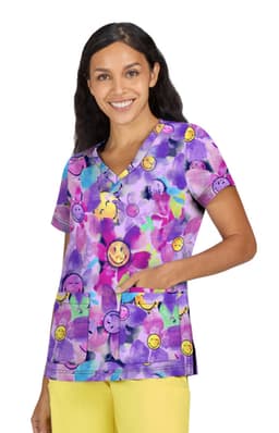 A vibrant purple scrub top featuring cheerful smiley faces and pockets, worn by a smiling woman.