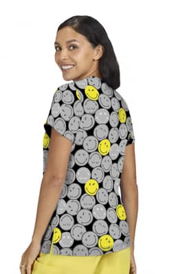 A short-sleeved women's top featuring a playful pattern of grey and yellow smiley faces, with a logo prominently displayed.