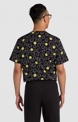 A black top featuring a playful print of various colourful smiley faces, shown from the back.
