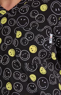 A patterned top featuring yellow and white smiley faces on a black background, with a pocket and a logo tag.