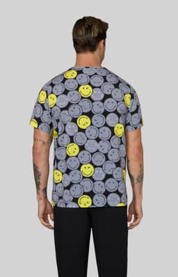 A patterned T-shirt featuring grey smiley faces and bright yellow accents, with a plain grey background.