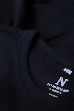 A black men's T-shirt featuring a round neckline and a subtle branding logo on the collar.