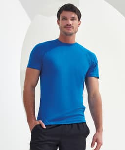 A panelled tech T-shirt in bright blue, featuring a fitted design and short sleeves. The model poses against a neutral background.