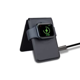 A grey magnetic card wallet and wireless charging stand with a smartwatch resting on it, connected by a charging cable.