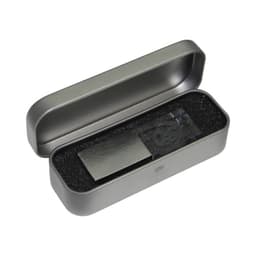 A 3D crystal flash drive in a grey metal case, resting on black foam padding. The case is open.