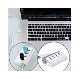 A USB hub in white with four ports, connected to a laptop, featuring various USB devices plugged in.