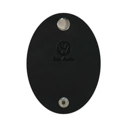 A black oval cable tidy with a metallic button and a logo. Suitable for managing cables and cords.