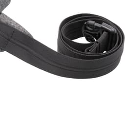 A grey anti-theft sling bag with an adjustable strap and a clip closure. It features a simple design and is quite compact.