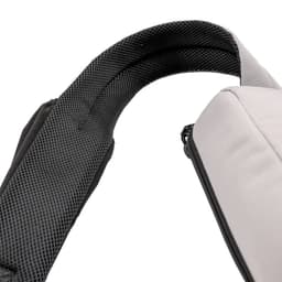 A grey eco bag with a black padded strap, featuring a textured interior. It includes a logo on the exterior.