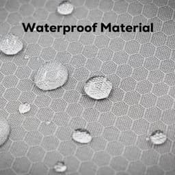 A close-up of waterproof material with water droplets on a textured, hexagonal pattern in light grey.