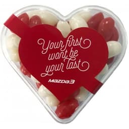 Acrylic heart-shaped container filled with red and white mini jelly beans, featuring a logo and festive design.