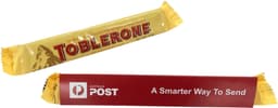 A yellow Toblerone chocolate bar with a sleeve, featuring a logo and promotional text.