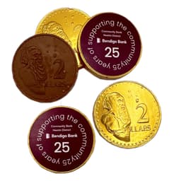 Chocolate coins in gold and brown, featuring monetary designs and a logo.