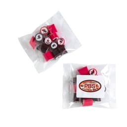A clear bag containing colourful rock candy pieces in red, pink, and brown, featuring decorative designs and a logo.