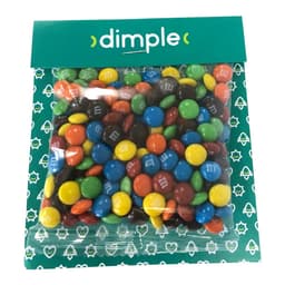 A bag of colourful M&M chocolates in various shades including red, blue, green, orange, and brown, with branding.