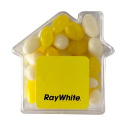 A clear acrylic house-shaped container filled with yellow and white jelly beans. It features a logo on the front.