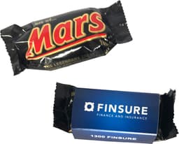A Mars Bar wrapped in black packaging with bold red lettering, alongside a blue box featuring a logo.