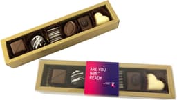 A gold box containing assorted pralines, including dark, milk, and white chocolates, with decorative patterns.