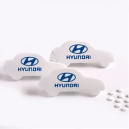 Car-shaped mint cards in white with a logo, surrounded by small white mint tablets on a light background.