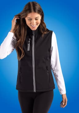 A black softshell vest featuring a zip front and side pockets, worn over a long-sleeved top.