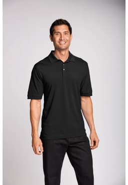A black polo shirt with a collar, featuring a logo, worn by a smiling male model against a neutral background.