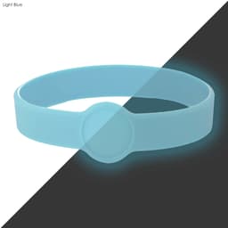A light blue silicone wristband with a circular imprint area and a glowing effect.