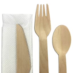 A wooden cutlery set featuring a knife, fork, and spoon, accompanied by a napkin. All components are light brown.