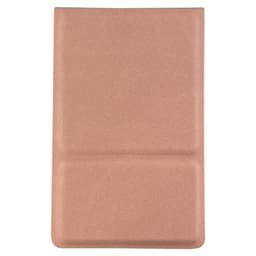 A compact mirror in a soft pink case with a textured finish and a logo.