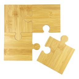 A bamboo coaster set featuring four interlocking puzzle pieces in a natural finish.