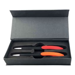 A gift set featuring two black pens with red and orange accents in a sleek grey box.