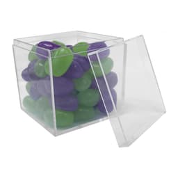A clear cube container filled with green and purple jelly beans, partially open.
