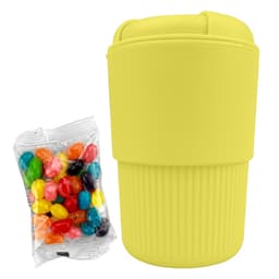 A drink bottle in bright yellow silicone, accompanied by a packet of colourful jelly beans. Features a logo on the side.