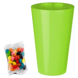 A bright green cup next to a packet of assorted jelly beans in various colours.