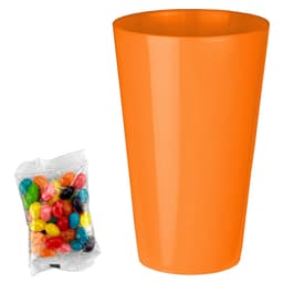 An orange party cup beside a clear packet of assorted jelly beans in various vibrant colours.