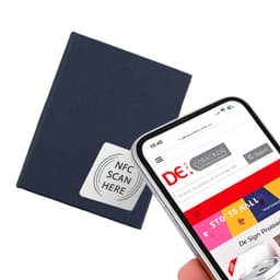 A navy notebook with an NFC tag is displayed alongside a smartphone scanning a webpage.