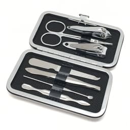 A silver manicure set contains scissors, nail clippers, tweezers, and other grooming tools in a compact case.
