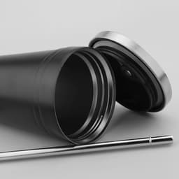 A drink bottle featuring a black body, silver lid, and metal straw, showcasing a sleek design and logo.