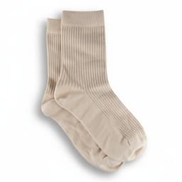 A pair of light beige ribbed socks with a soft texture, featuring a subtle design and a branded logo.