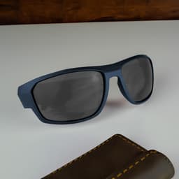 A pair of blue sunglasses with dark lenses rests on a light surface beside a brown case.