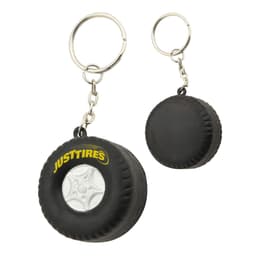 A black stress tyre key ring featuring a small tyre design and a metal keychain attachment, with a logo.