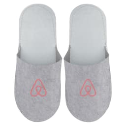 Grey felt slippers featuring a logo on the front, designed for comfort and cosy wear.